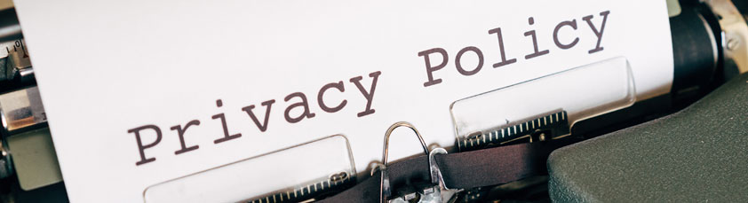 The words privacy policy appear on a manual typewriter